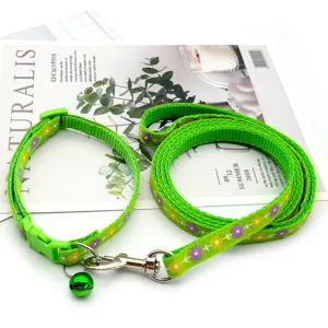 Green floral pet collar and leash set with bell, adjustable outdoor walking gear for pets.