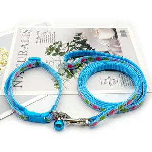 Blue flower pet leash and collar set, detailed view of floral woven strap and metal bell.