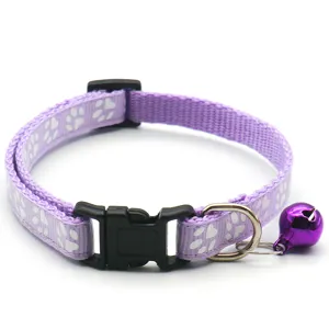 Détail de collier pour animal de compagnie violet avec boucle et motif de pattes.