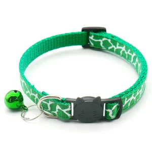Green cat collar detail view with cute cat face buckle, bell and metal D-ring for pets.