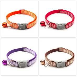 Close-up details of colorful plaid pet cat collars equipped with buckles and small bells.