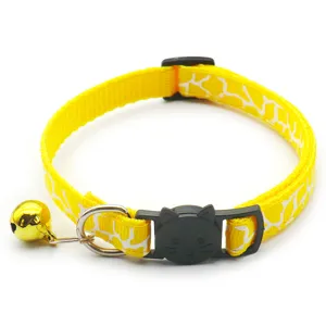 Yellow printed pet cat collar detail featuring cute black cat face buckle and gold bell.