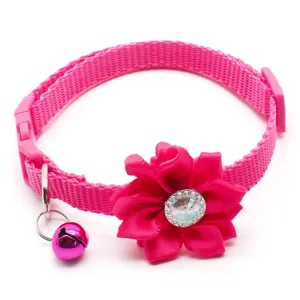 Pink cat collar with fabric flower rhinestone and bell detail, perfect pet accessory.