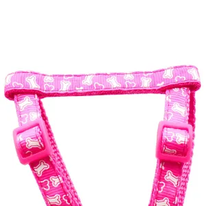 Close up detail of pink bone pattern pet dog harness strap with plastic buckles.