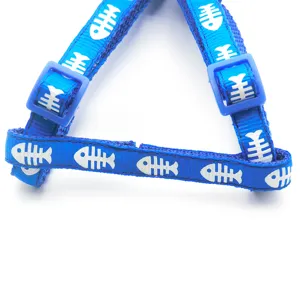 Blue pet harness detail featuring a fun white fish bone print and adjustable plastic buckles.