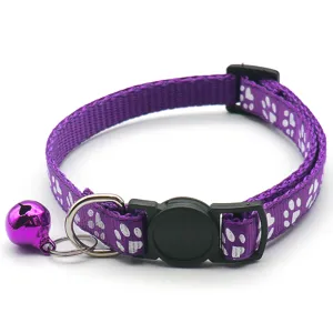 Purple pet collar with cute white paw print pattern, adjustable design and hanging bell.