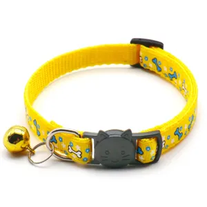 Yellow pet collar detail view featuring cute blue bone print, black cat buckle and gold bell.
