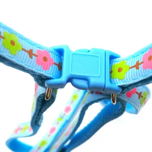 Close-up detail of blue floral pet harness buckle and strap, durable adjustable pet accessory.