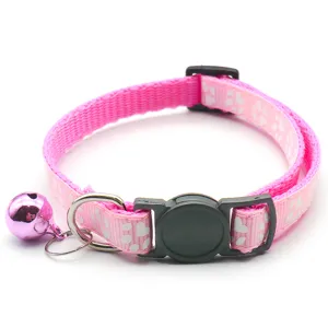 Pink nylon pet collar with bell, cute paw print design, adjustable buckle for cats and dogs.