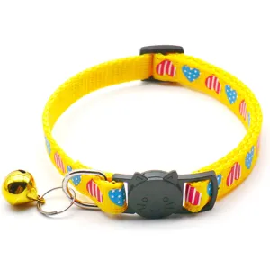 Yellow heart print pet collar detail, featuring a cute cat buckle and metal bell.