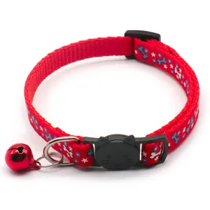 Close-up red pet collar with blue bone print, cute cat buckle and red bell detail.