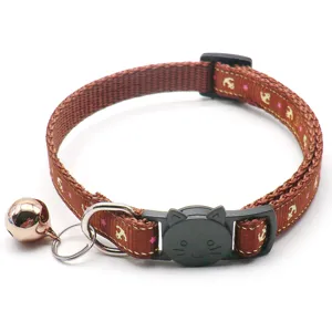 Detail view of brown pet collar featuring anchor print, cat shaped buckle and bell for small pets.