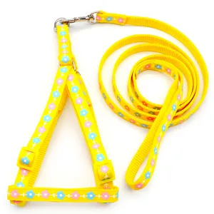 Yellow pet harness and leash set with cute blue and pink floral print for dogs and cats.