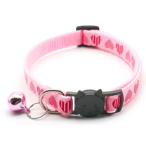 Pink pet collar detail shot featuring cute heart print and a black cat safety buckle.