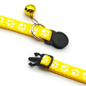 Adjustable yellow pet cat collar with paw prints, metal bell and quick release buckle.
