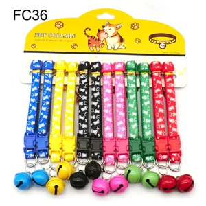 Close-up of colorful pet collars with big bells and cute bone patterns on a card.