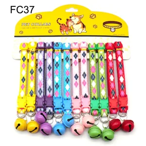 Detailed view of colorful pet collars with bells, argyle pattern and plastic buckles.