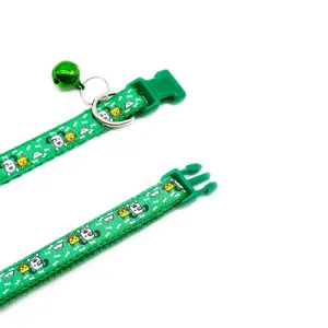 Green cartoon print pet collar with metal bell, adjustable plastic buckle and D-ring.