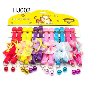 Detail view of colorful pet collars featuring fabric straps, chiffon bows and cute metal bells.