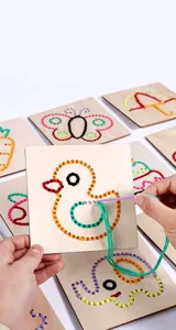 Wooden threading embroidery sewing board toy detail showing hands practicing fine motor skills.