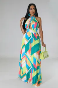 Halterneck pleated chiffon maxi dress with vibrant geometric print and backless resort style.