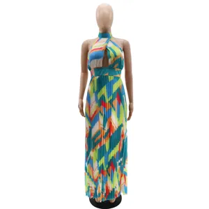 Detailed view of the halter neck, cutout detail, and colorful geometric pleated chiffon fabric.