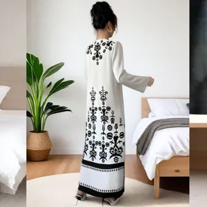 Back view detail of women elegant long sleeve black and white floral print maxi dress.