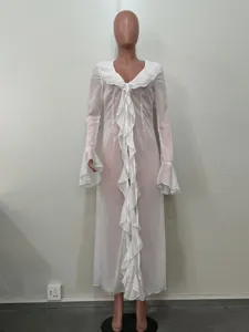 Detailed view of sheer white beach cover-up with delicate ruffles and deep V-neck style.