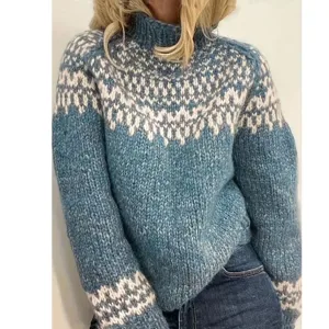 Closeup detail showing the cozy blue and white Nordic patterned turtleneck knit sweater.