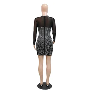 Detailed back view of a black sheer mesh rhinestone long sleeve bodycon party mini dress.