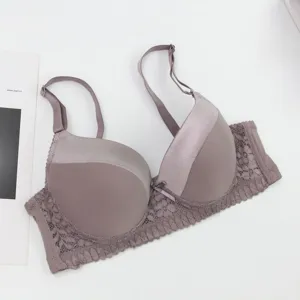 Close-up of elegant purple push-up bra with smooth satin cups and delicate floral lace wing.
