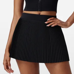 Detail shot of black pleated sports tennis skort, showing high waist and quick-dry fabric.