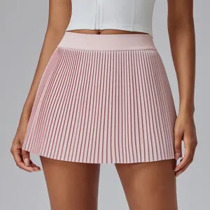 Detailed view of the pink pleated tennis skort, showing fine pleats and high waist design.