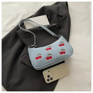 Stylish denim shoulder bag featuring cute cherry embroidery. Perfect casual daily purse.
