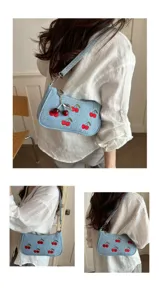 Denim shoulder bag with red cherry embroidery and cute metal charm, casual and chic.