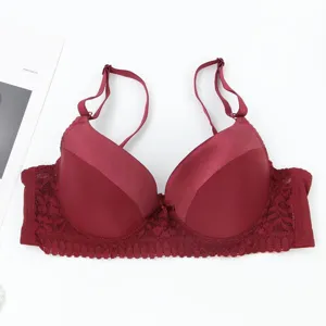 Detailed view of women burgundy push-up bra with smooth cups and delicate lace trim.