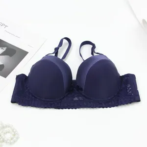 Detailed view of the deep blue push-up bra featuring smooth cups and delicate lace wings.