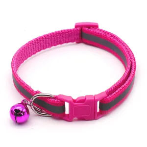 Pink reflective pet collar detail shot showing nylon strap, safety buckle and cute bell.