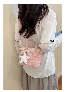 Pink plaid bucket bag detail showing lace trim and cute white star pendant worn by model.