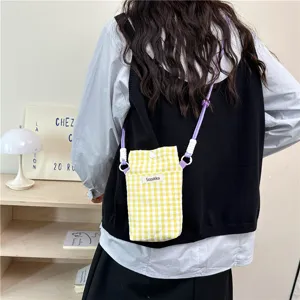 Yellow and white gingham crossbody phone bag with purple strap and adjustable buckle.