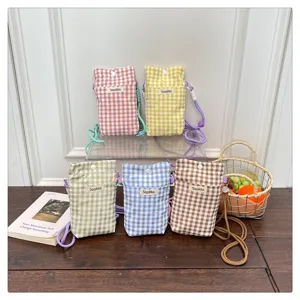 Plaid mobile phone bag detail showcasing multi-color fabric mini crossbody pouch with cute strap.