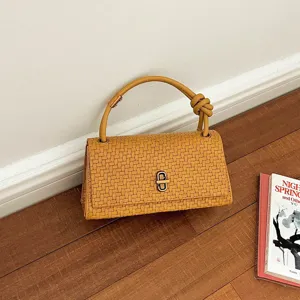 Retro woven baguette handbag with stylish knot handle, elegant shoulder purse for daily commute.