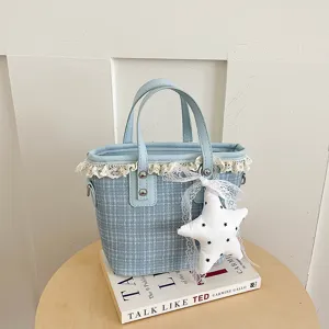 Detailed view of the Korean style plaid bucket bag with cute lace trim and star charm.