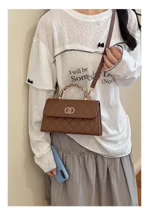 Chic brown quilted chain shoulder bag with elegant metal handle and crossbody strap style.