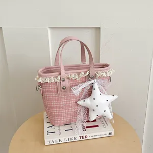Pink tweed bucket bag detail showcasing delicate lace trim and cute star pendant charm.
