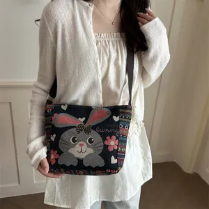 Umhängetasche aus Canvas mit niedlicher Hasenstickerei und gewebten Ethno-Trägern für Damen.