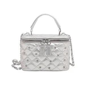 Silver quilted vanity handbag with chain strap, stylish mini shoulder and crossbody bag for women.