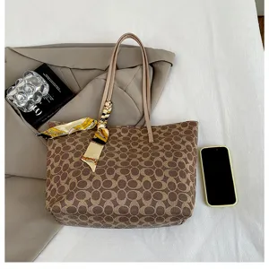 Elegant brown monogram tote bag for women, large capacity shoulder bag with stylish scarf decor.