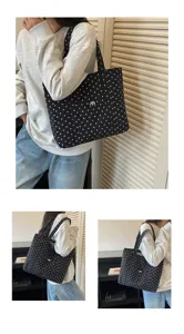 Vue détaillée du sac cabas à pois noirs en toile, doté d'une poche avant et d'une sangle solide.