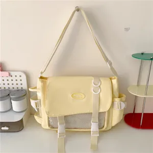 Cute Japanese college style canvas messenger bag with transparent front pocket for students daily use.